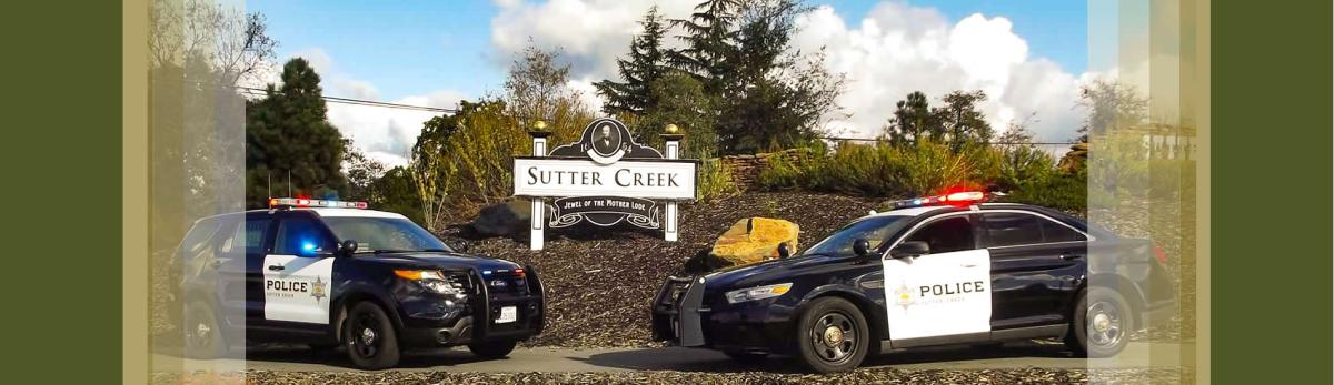 Police cruisers in front of Sutter Creek sign